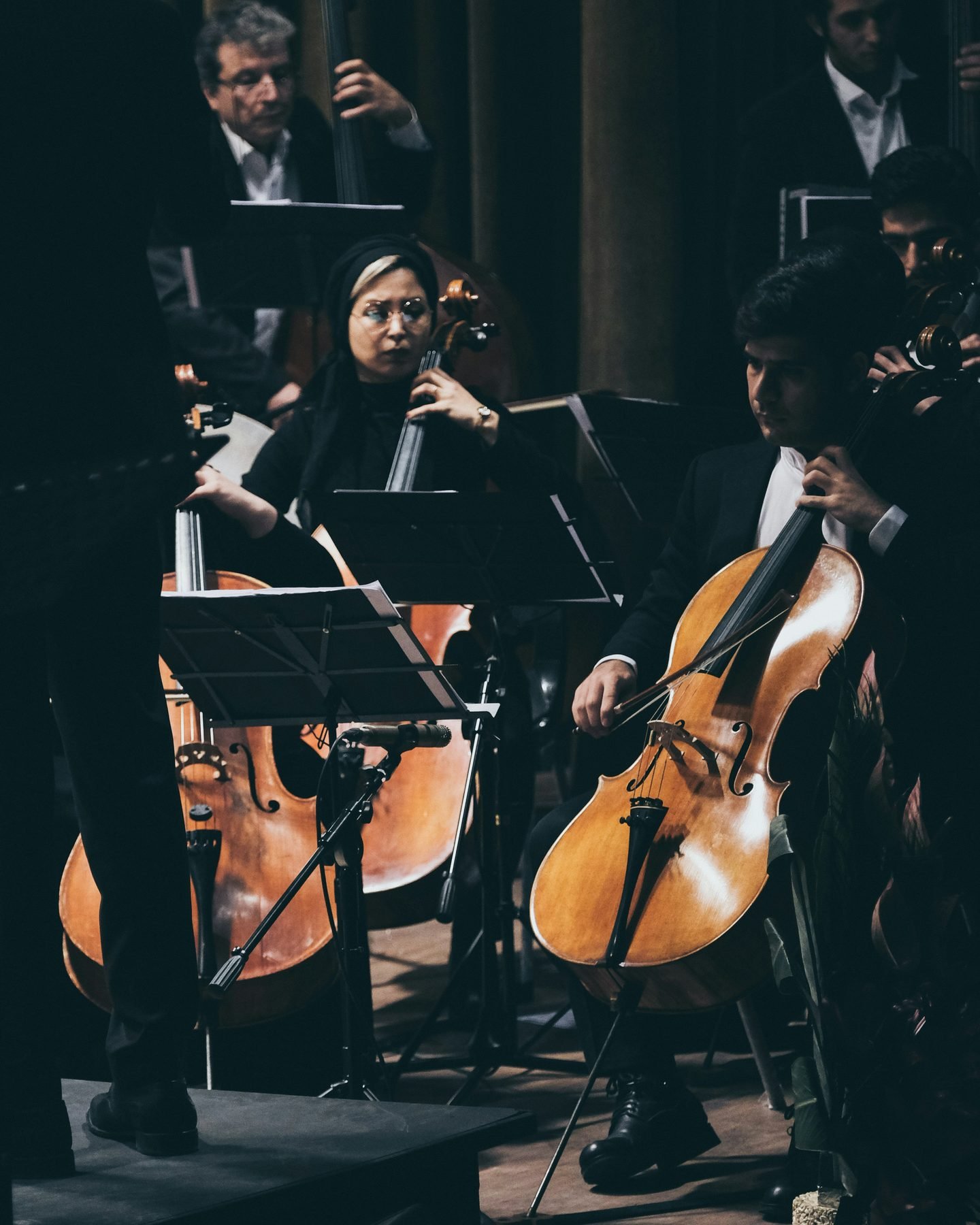 A violinist in a black gown performing at an intimate private celebration