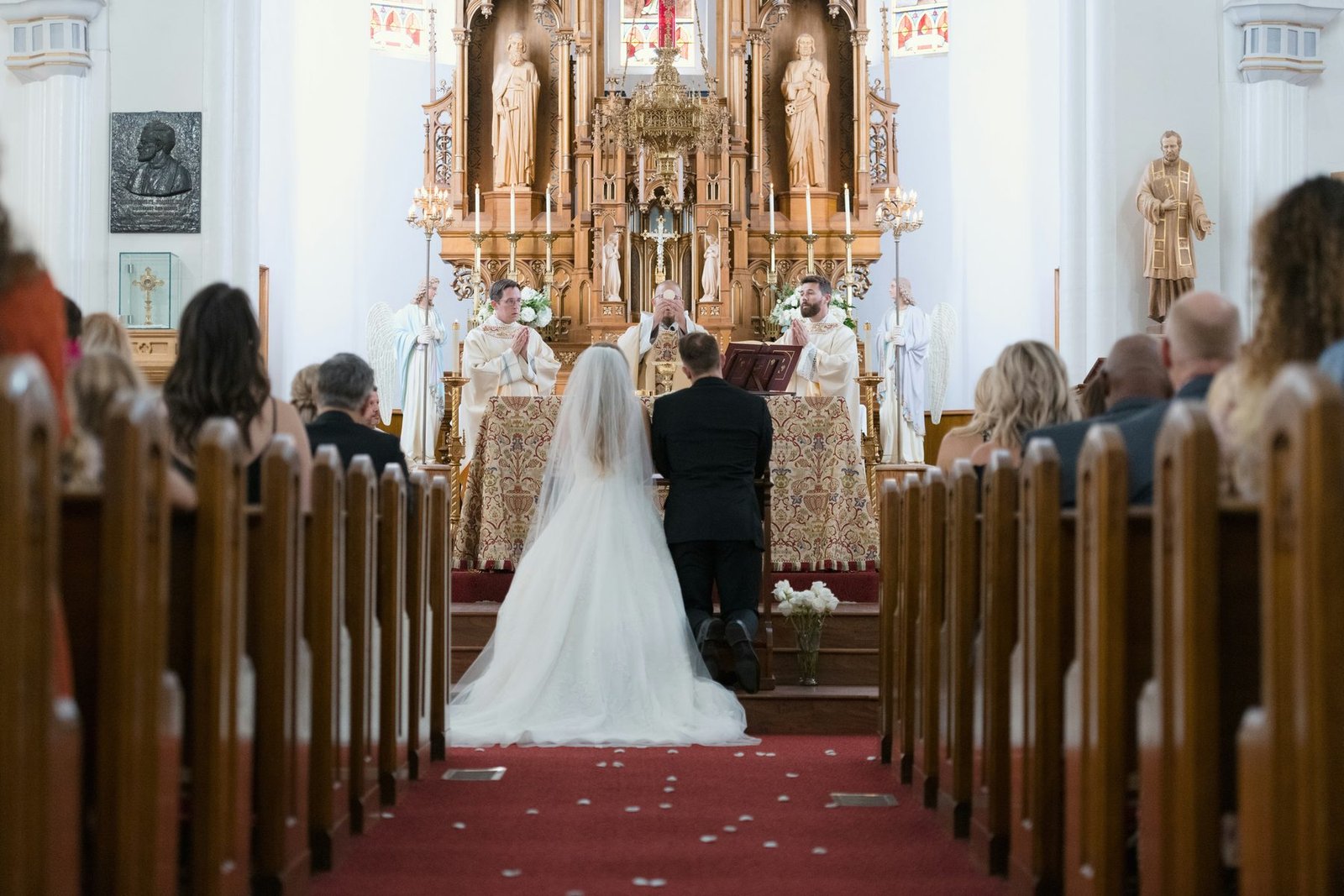 A bride and groom walking down the aisle to live violin accompaniment